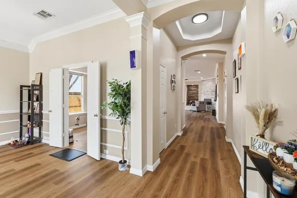 a view of a hallway with wooden floor and entryway