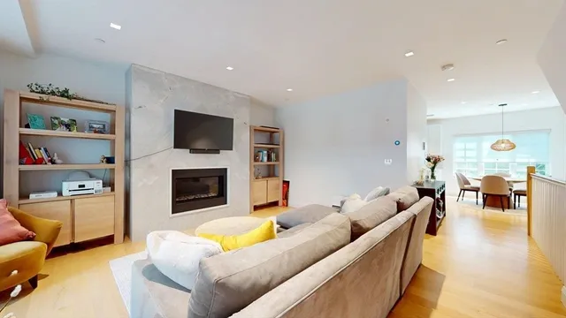 a living room with furniture flat screen tv and a fireplace