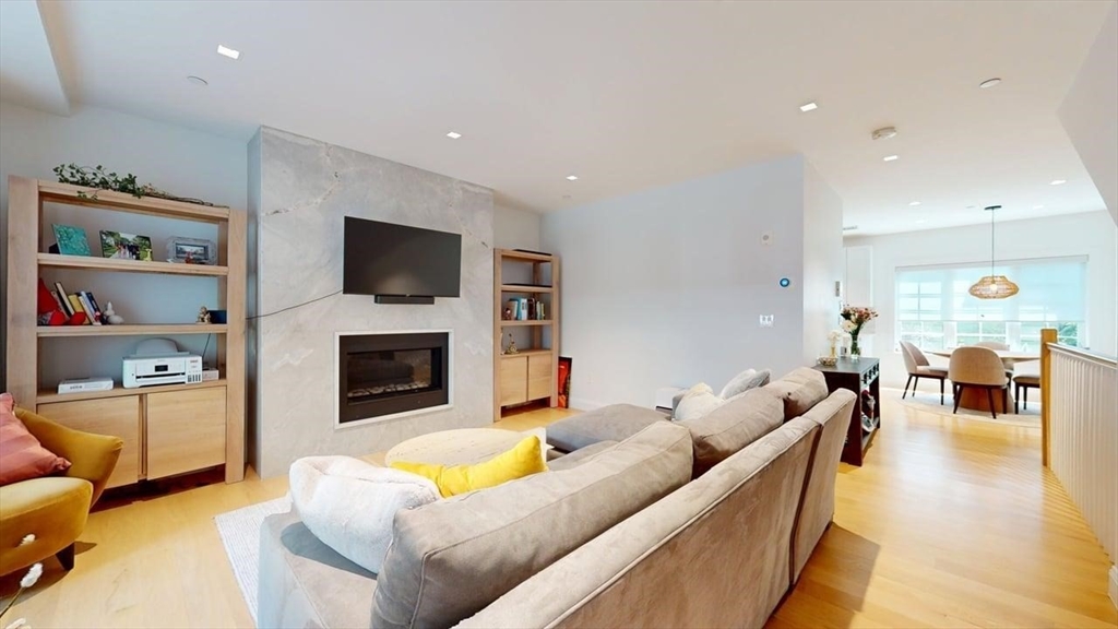 21 Crowninshield Road, Unit 17 Brookline, MA 02446 - Photo 1 of 29 a living room with furniture flat screen tv and a fireplace