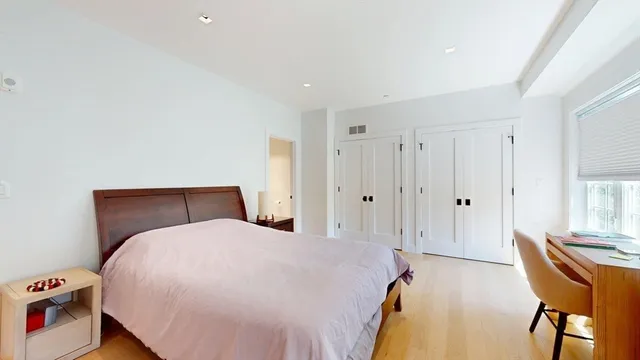 a bed room with a bed and a chair