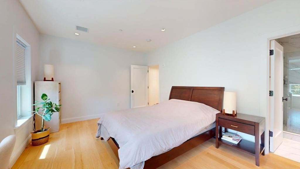 21 Crowninshield Road, Unit 17 Brookline, MA 02446 - Photo 12 of 29 a bedroom with a bed and a potted plant