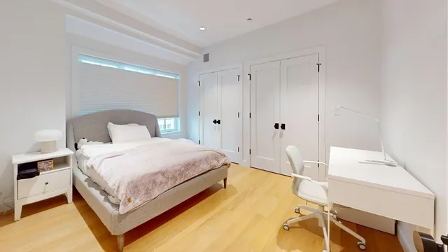 a bedroom with a bed and a table