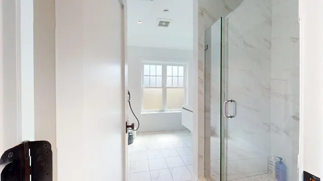 a bathroom with a tub and shower
