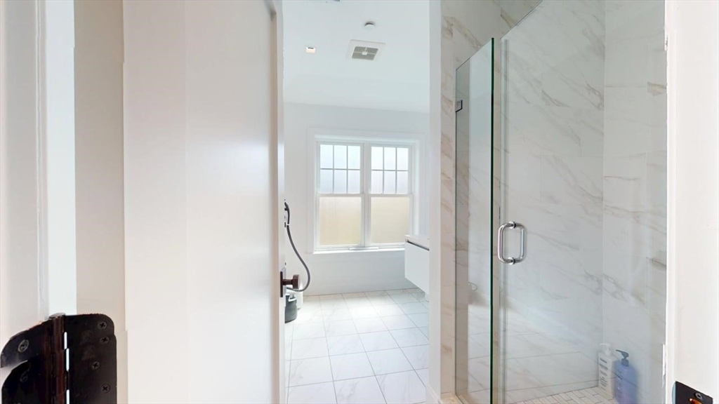 21 Crowninshield Road, Unit 17 Brookline, MA 02446 - Photo 21 of 29 a bathroom with a tub and shower