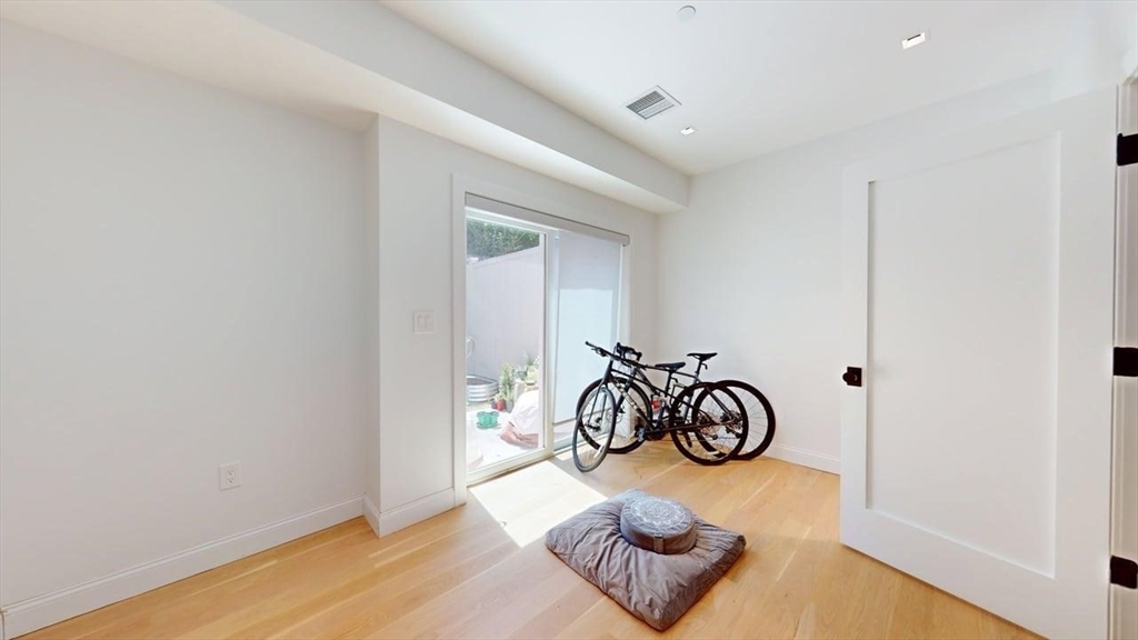 21 Crowninshield Road, Unit 17 Brookline, MA 02446 - Photo 23 of 29 a view of room with furniture and wooden floor