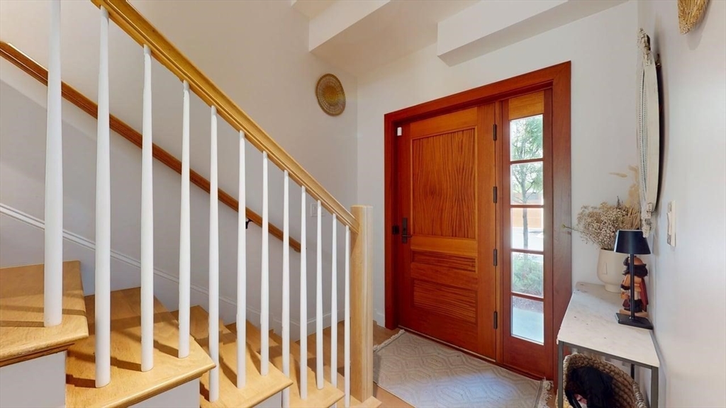 21 Crowninshield Road, Unit 17 Brookline, MA 02446 - Photo 25 of 29 a view of an entryway with wooden floor and windows