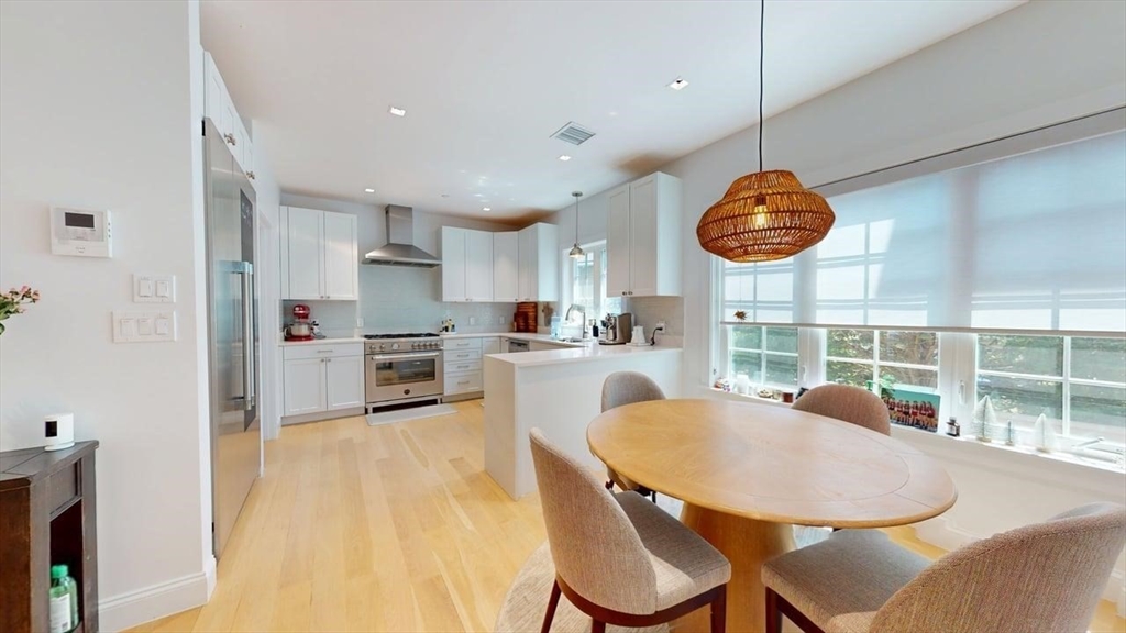 21 Crowninshield Road, Unit 17 Brookline, MA 02446 - Photo 3 of 29 a view of a dining room with furniture and chandelier