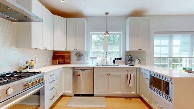 a kitchen with stainless steel appliances a stove a sink and a refrigerator