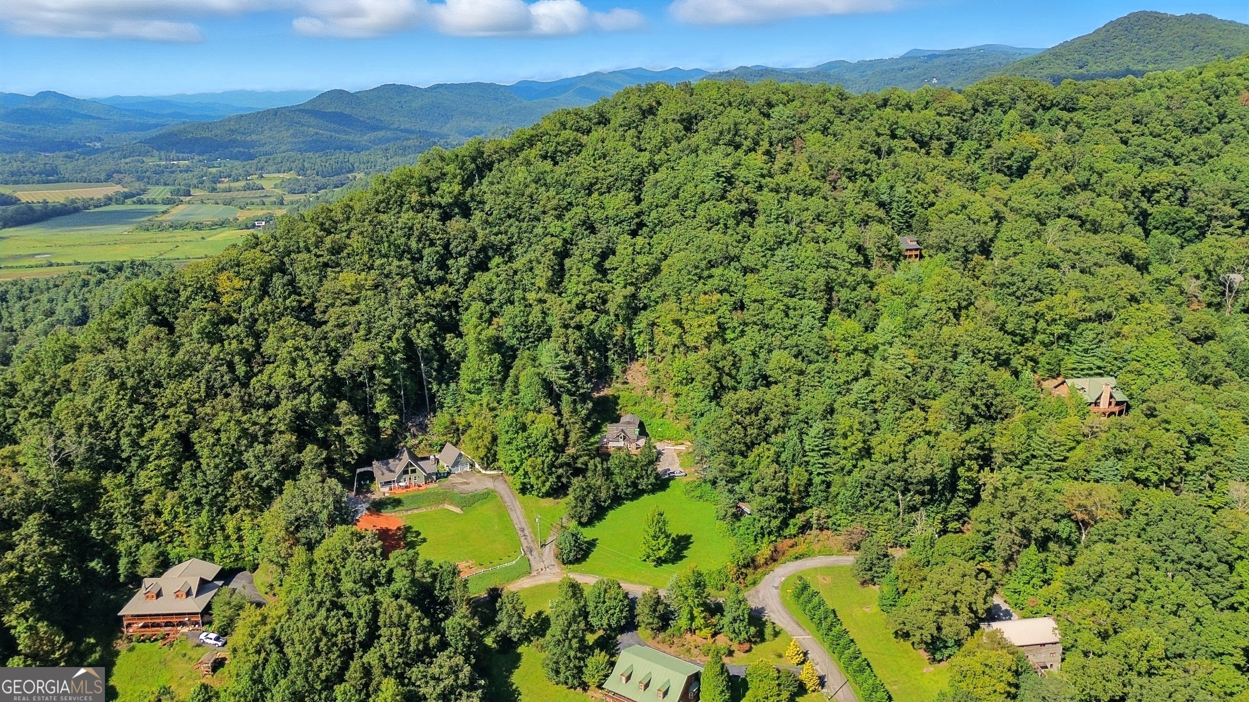 668 Mountainside Drive Rabun Gap, GA 30568 - Photo 5 of 24 a view of a lush green hillside and a houses