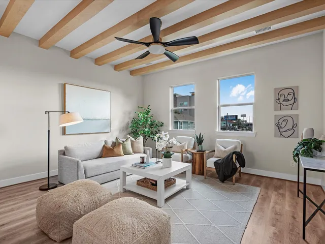 a living room with furniture a rug and a window