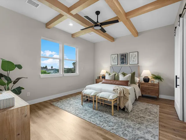 a bedroom with a bed and a potted plant