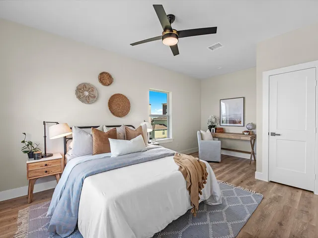 a bedroom with a bed and a view of kitchen