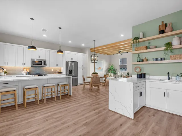 a large white kitchen with lots of counter space and appliances