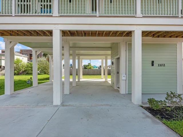 a view of an empty room with a fireplace and floor to ceiling window