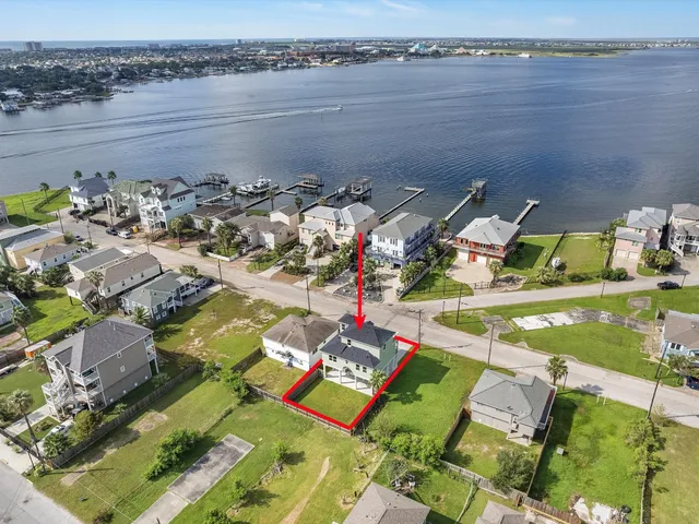an aerial view of a house with a lake