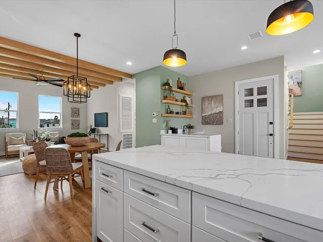 a view of a dining room with furniture and a chandelier