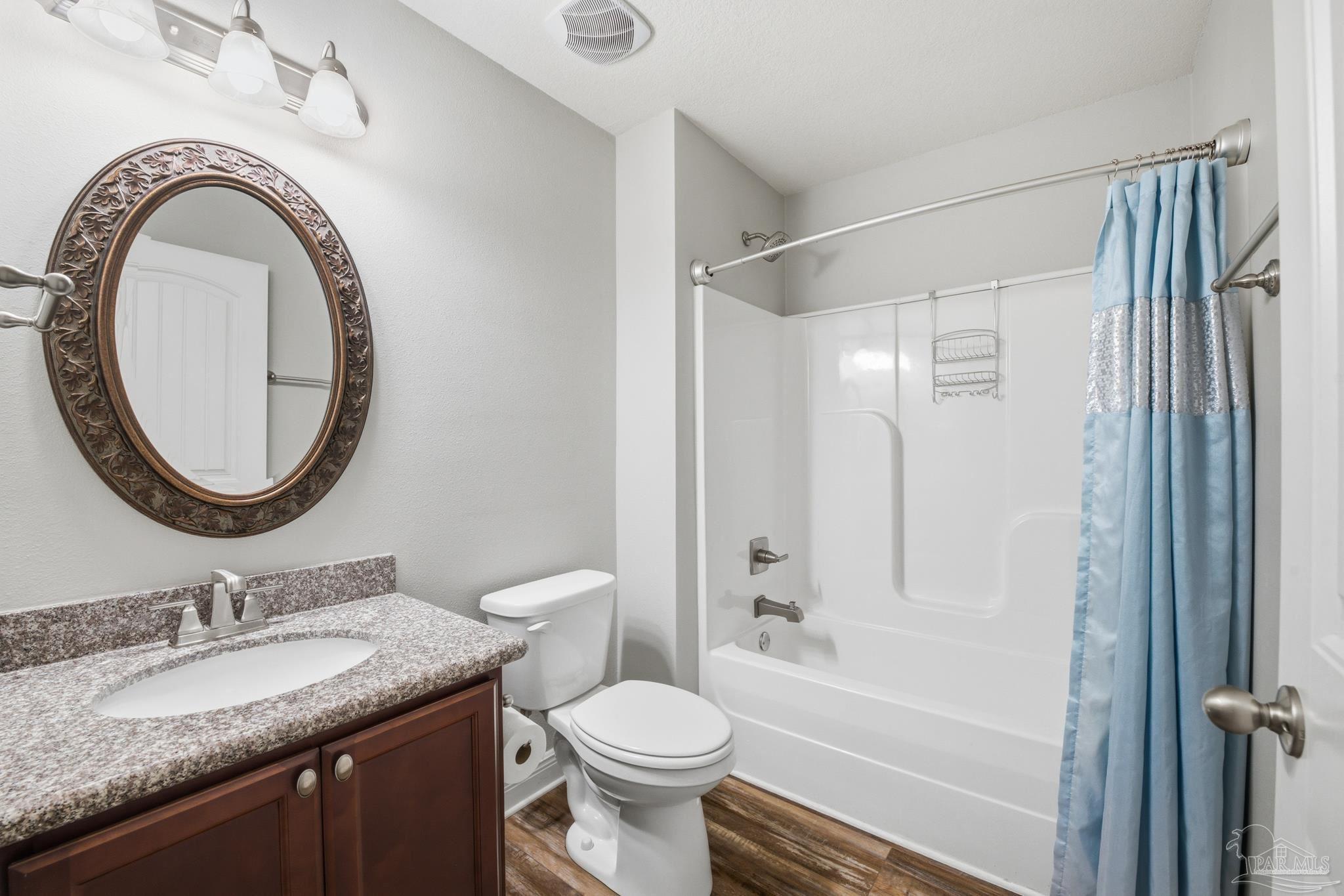 5661 Cane Syrup Circle Pace, FL 32571 - Photo 14 of 20 a bathroom with a granite countertop toilet sink and a mirror