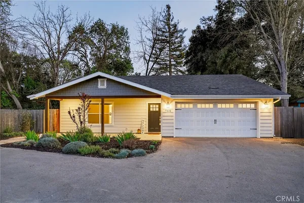 a view of a house with a yard and garage
