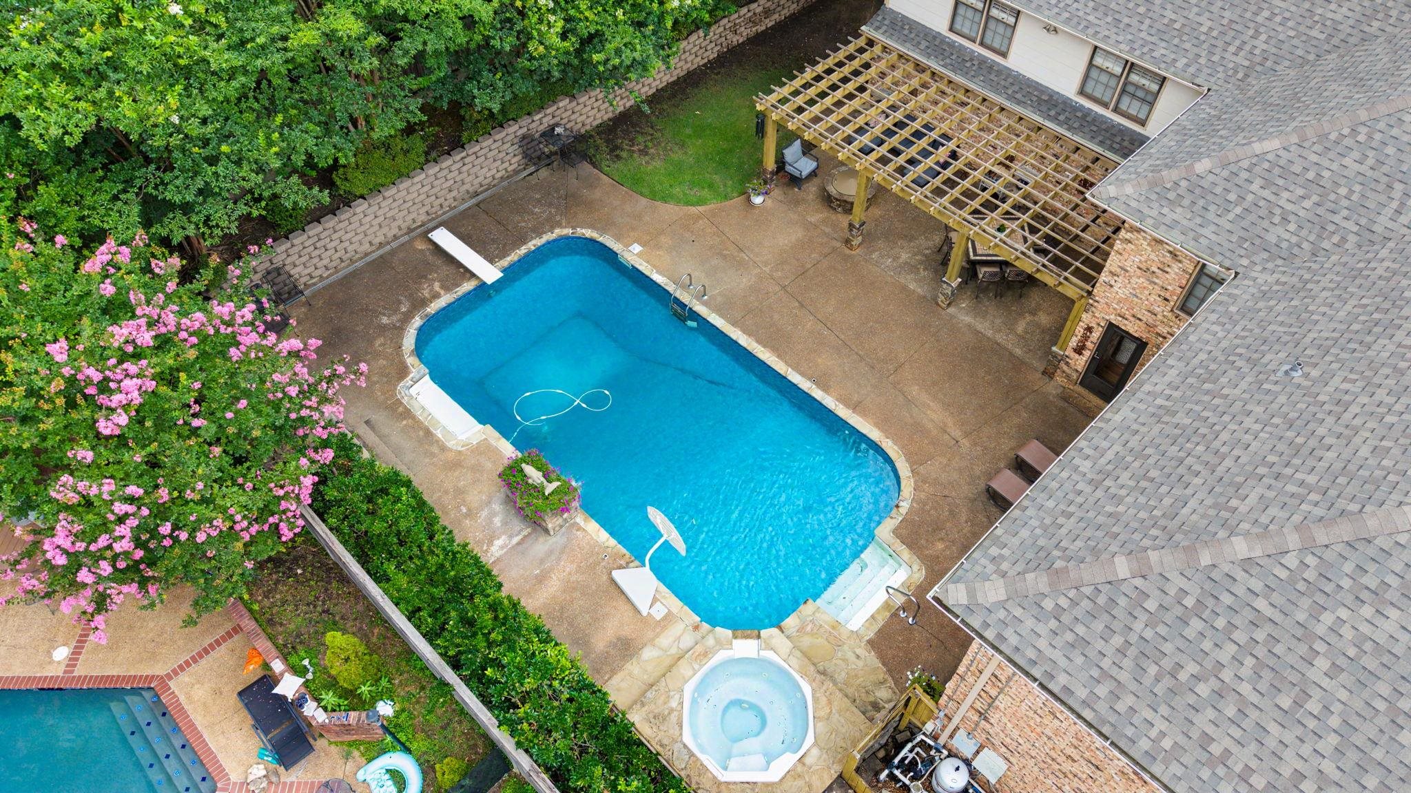 1929 Miller Farms Road Germantown, TN 38138 - Photo 38 of 40 Spacious backyard featuring a rectangular swimming pool with diving board, an integrated spa, and extensive concrete patio space