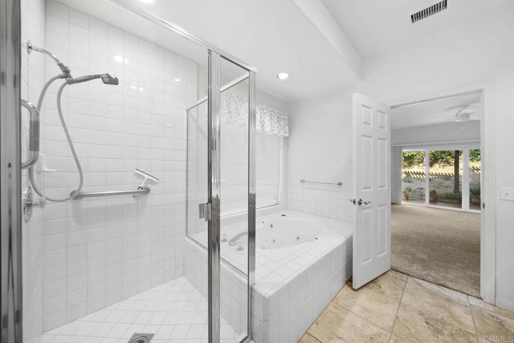 1861 Fox Bridge Court Fallbrook, CA 92028 - Photo 20 of 60 a bathroom with a bathtub and a shower