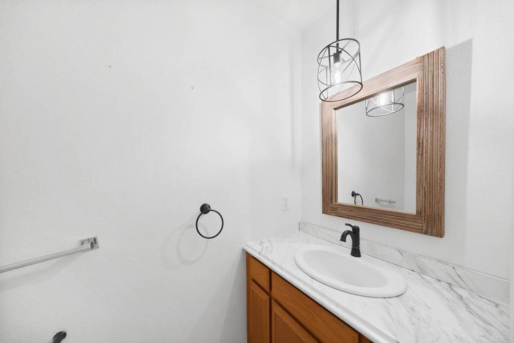 1861 Fox Bridge Court Fallbrook, CA 92028 - Photo 30 of 60 a bathroom with a sink and mirror