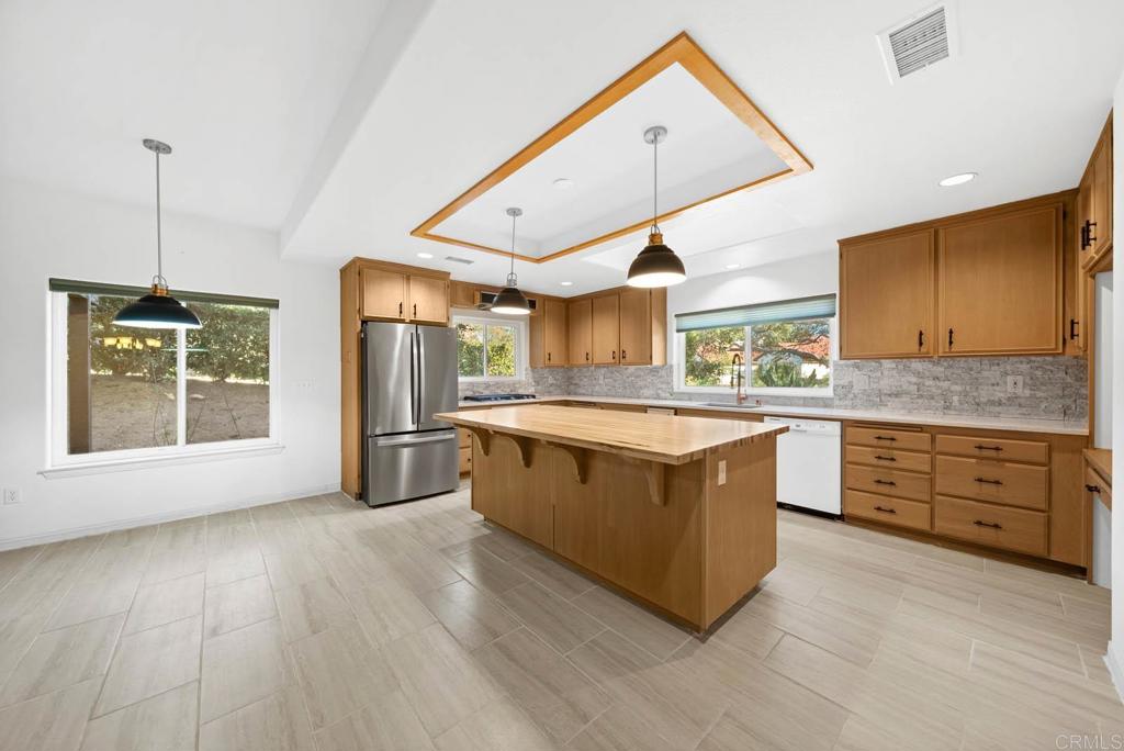 1861 Fox Bridge Court Fallbrook, CA 92028 - Photo 9 of 60 a large kitchen with stainless steel appliances granite countertop a stove and a wooden floors