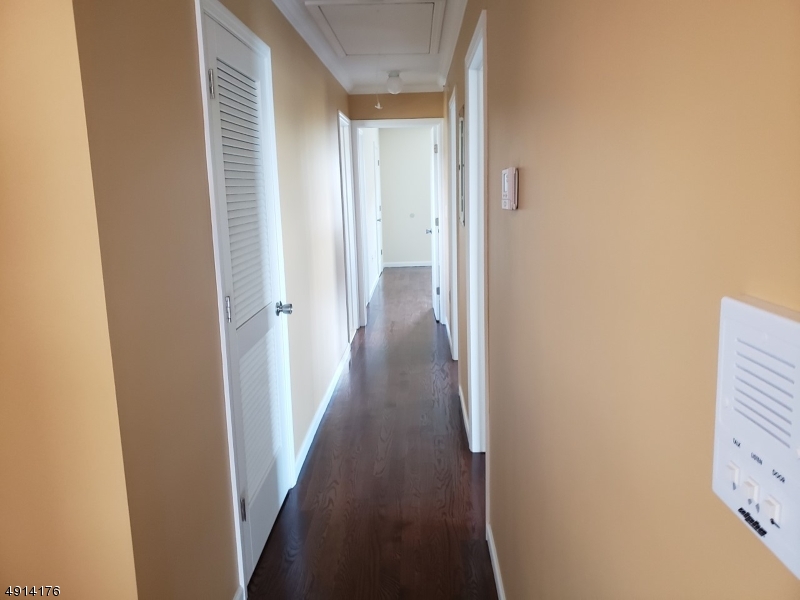 230 Erie Street, Unit 3 Elizabeth Port, NJ 07206 - Photo 4 of 6 a view of a hallway with wooden floor