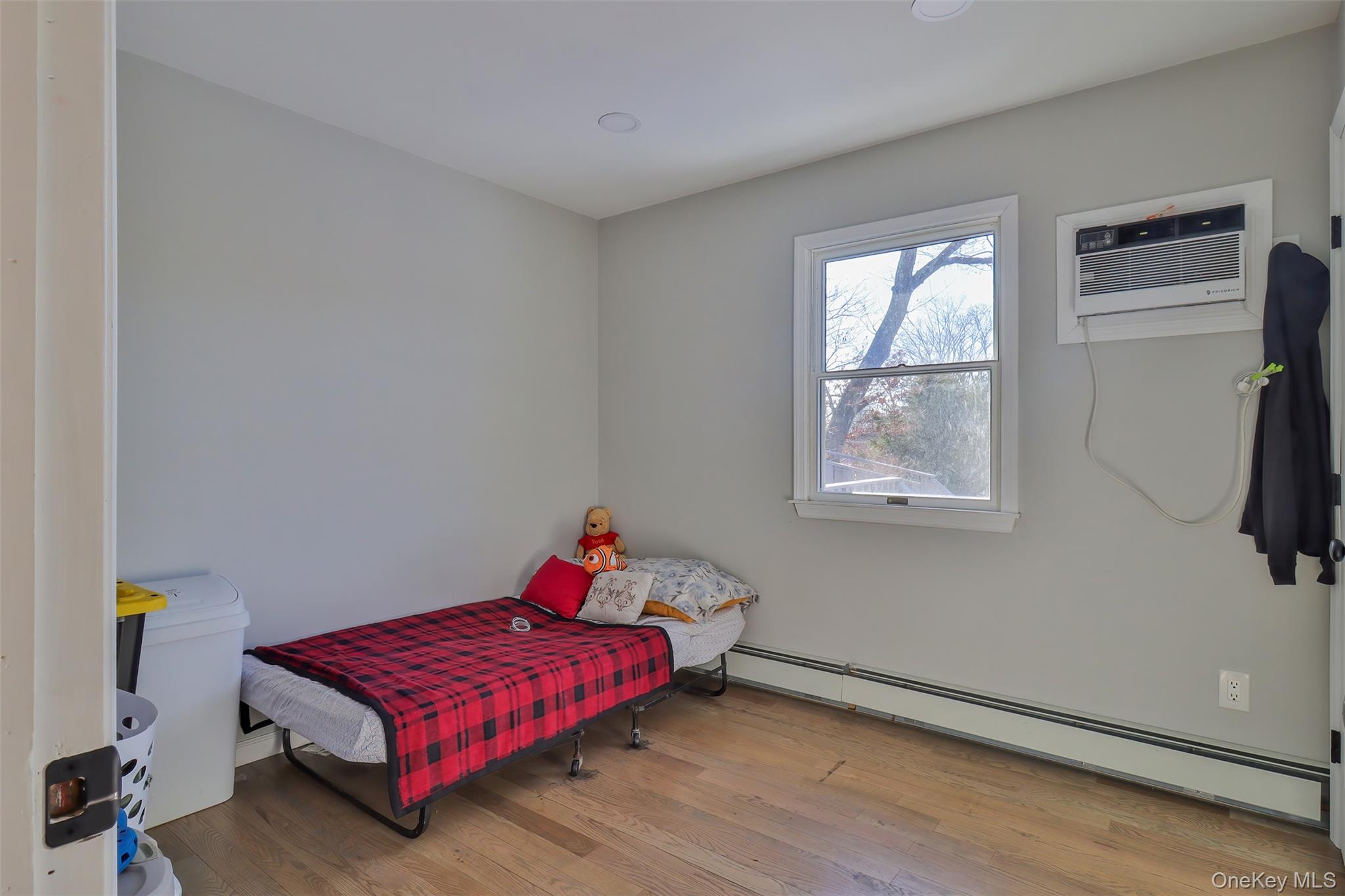 116 B Holbrook Road Holbrook, NY 11741 - Photo 13 of 23 a bedroom with a bed and a window
