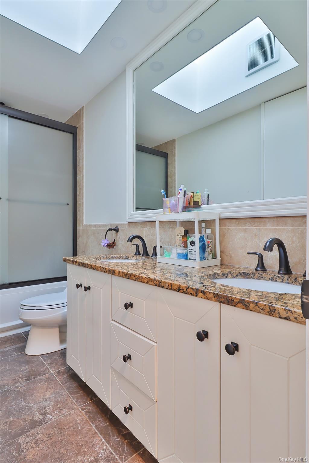 116 B Holbrook Road Holbrook, NY 11741 - Photo 10 of 23 a bathroom with a granite countertop toilet a sink and a mirror