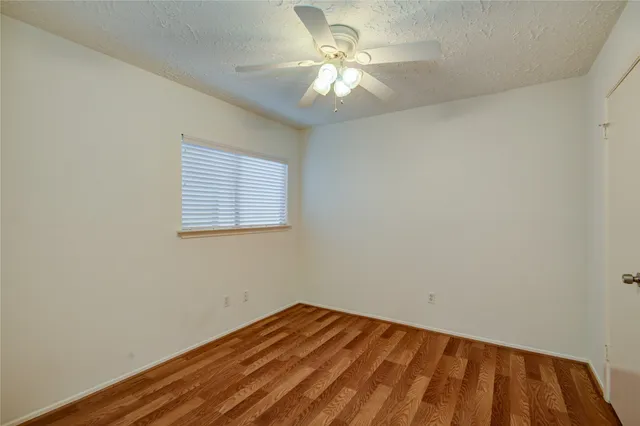 wooden floor in a room next to a window