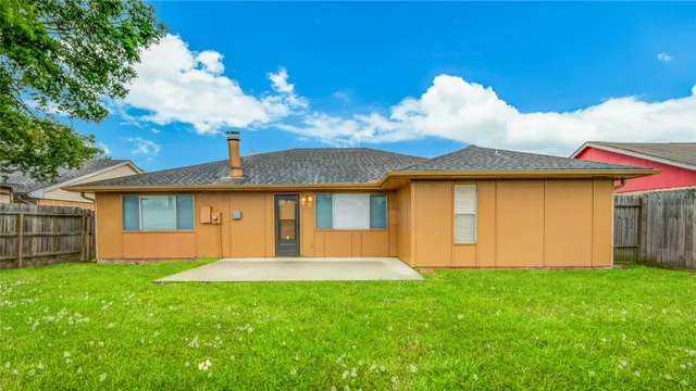 a view of yard with small huts and green space