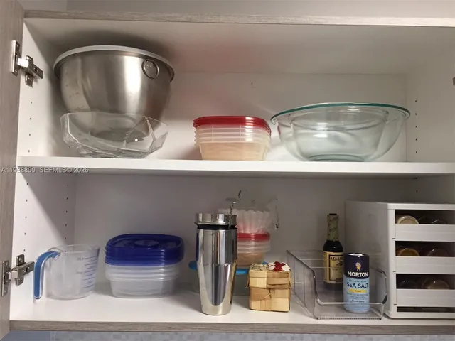 a room with lots of cabinet and mirrors