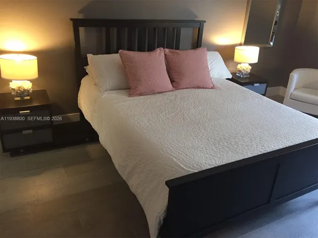 a bedroom with bed and window