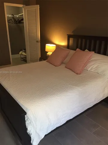 a bedroom with a bed and a mirror