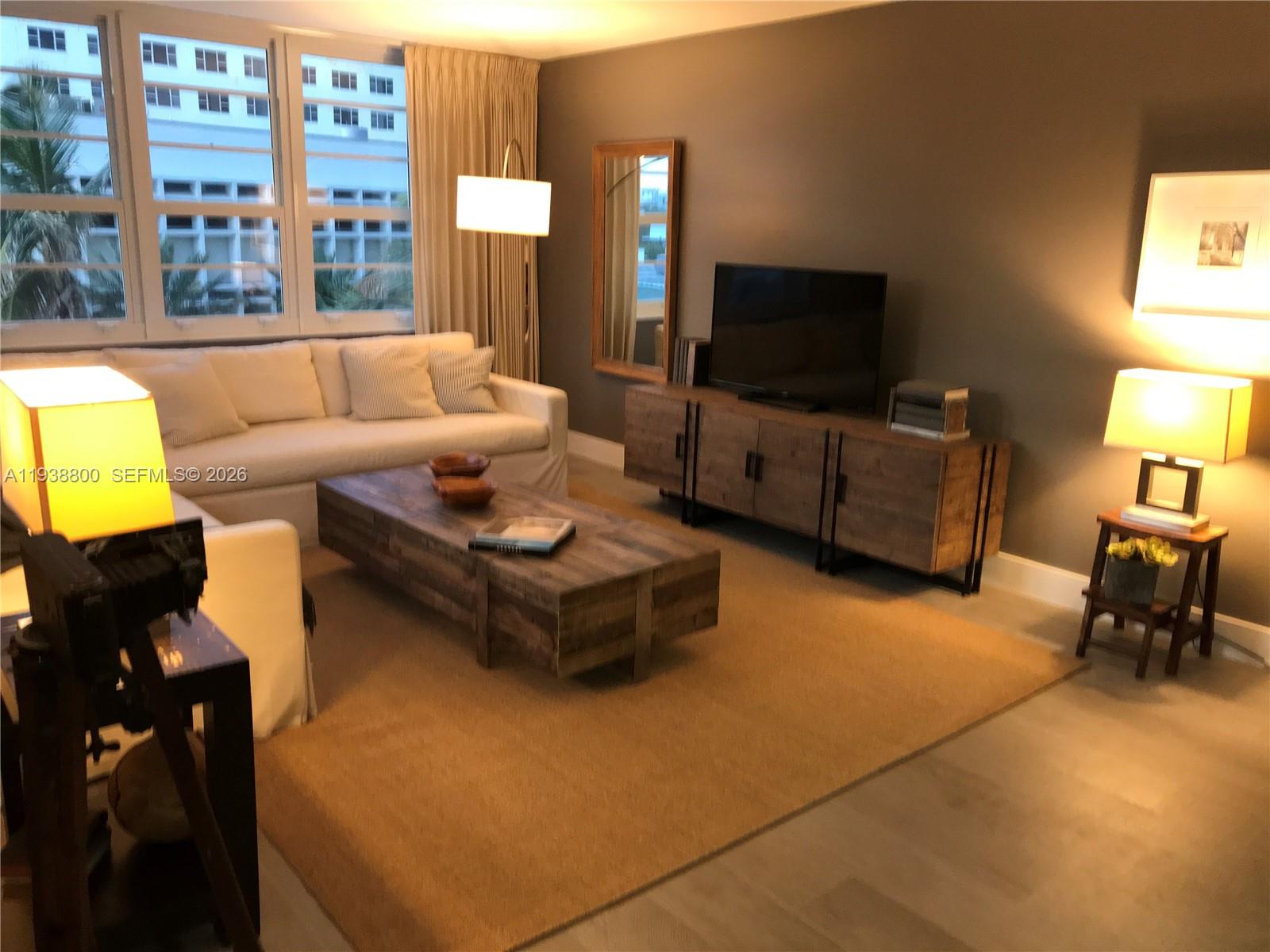 100 Lincoln Road, Unit 314B Miami Beach, FL 33139 - Photo 2 of 44 a living room with furniture and a flat screen tv