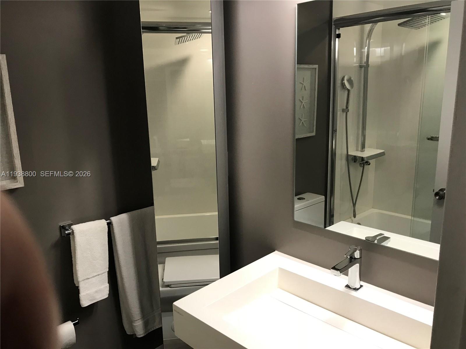 100 Lincoln Road, Unit 314B Miami Beach, FL 33139 - Photo 30 of 44 a bathroom with a sink and mirror