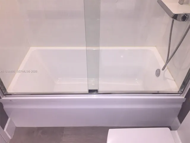 a bathroom with a shower and a sink