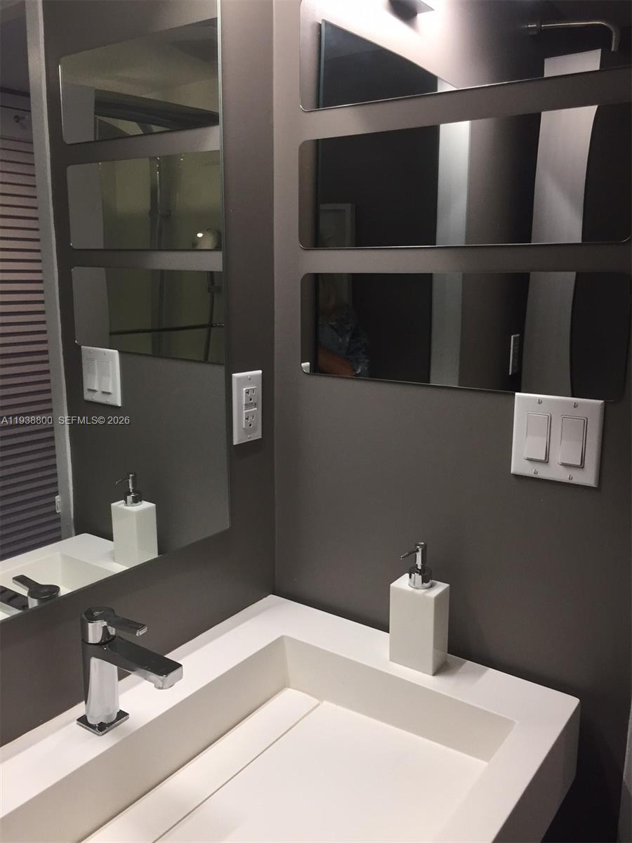 100 Lincoln Road, Unit 314B Miami Beach, FL 33139 - Photo 31 of 44 a bathroom with a sink and a mirror