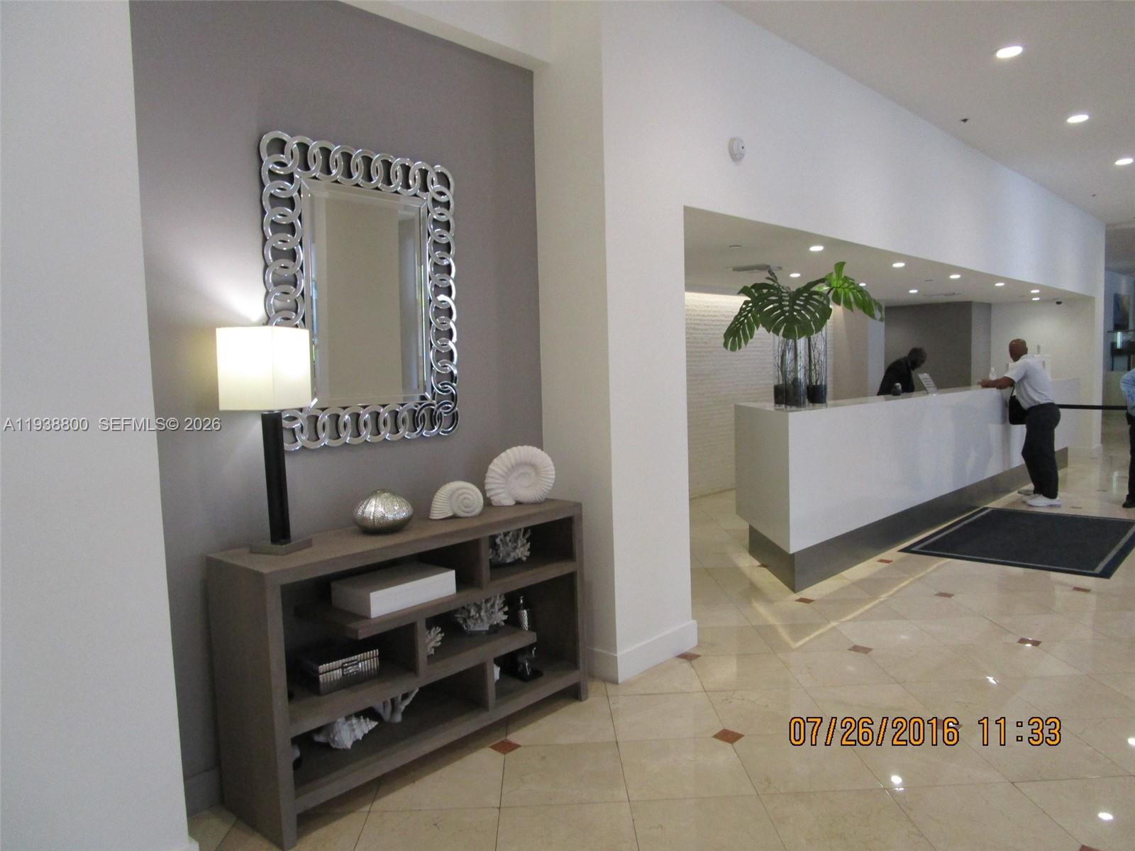 100 Lincoln Road, Unit 314B Miami Beach, FL 33139 - Photo 43 of 44 a living room with furniture and a lamp