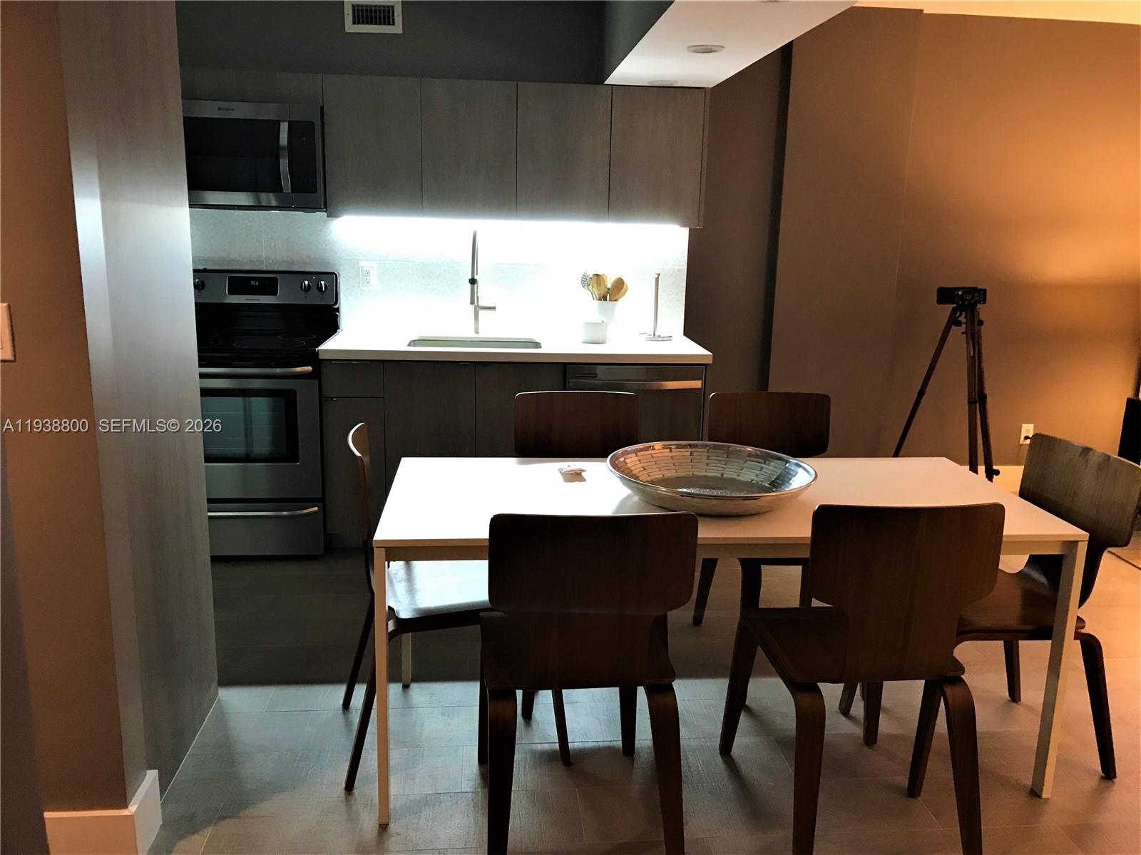 100 Lincoln Road, Unit 314B Miami Beach, FL 33139 - Photo 5 of 44 a view of a dining room with furniture and wooden floor