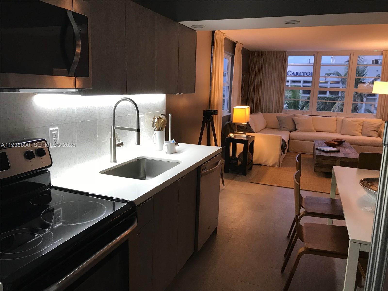 100 Lincoln Road, Unit 314B Miami Beach, FL 33139 - Photo 6 of 43 a kitchen with a table chairs and a kitchen