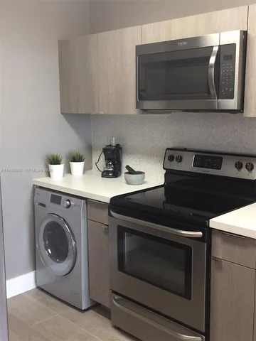 a kitchen with a stove and a microwave