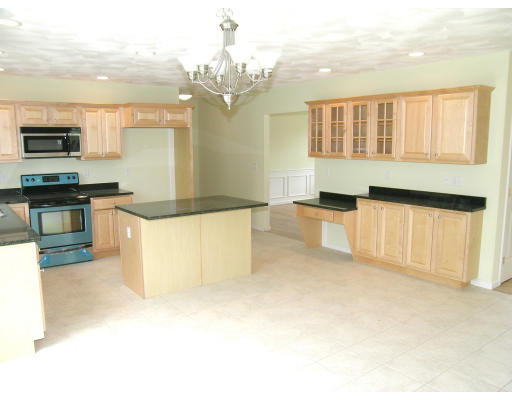 3 West Ledge Road, Unit LOT #2 Clinton, MA 01510 - Photo 3 of 16 a large kitchen with stainless steel appliances granite countertop a stove and a sink
