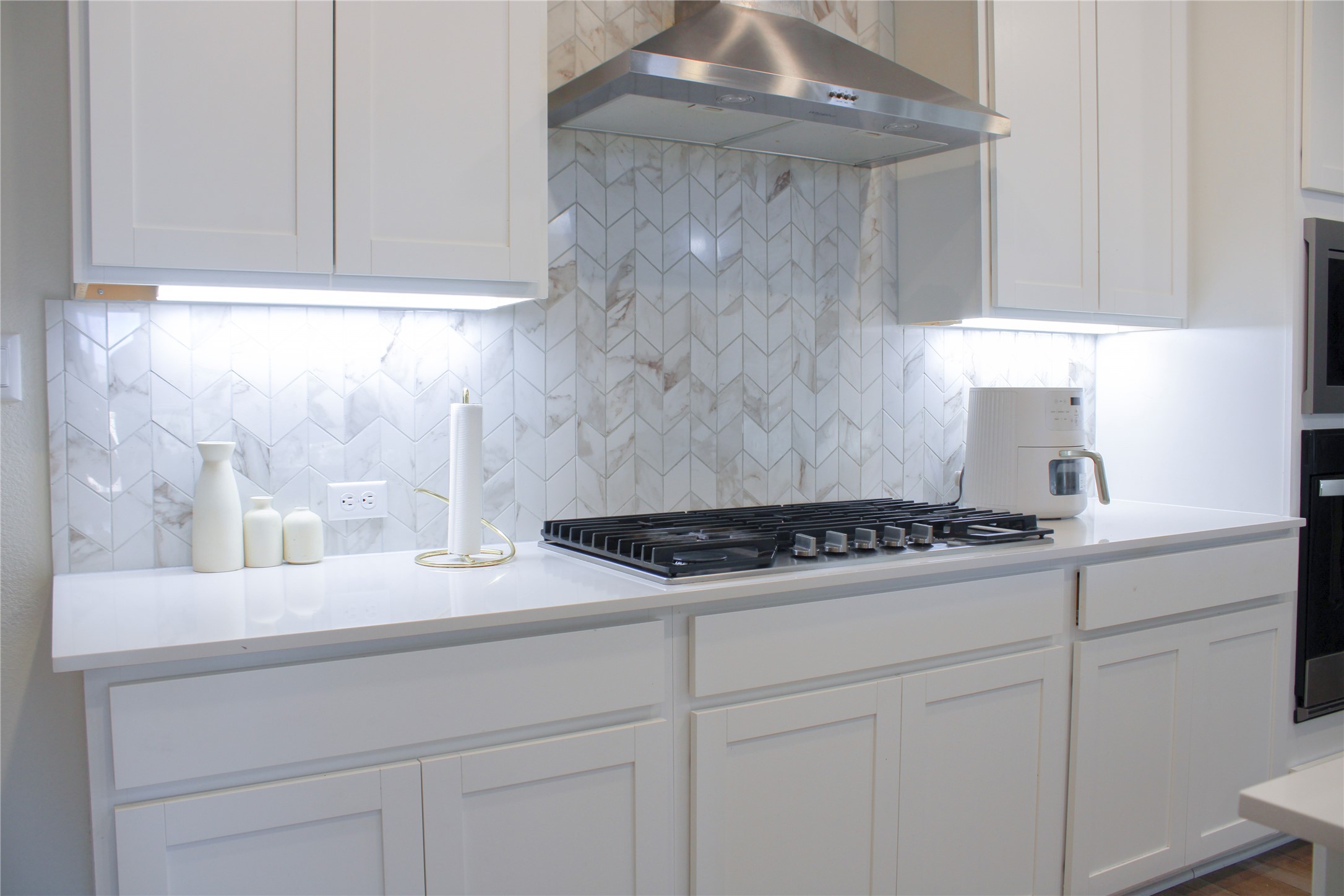 181 Tree Nut Loop Buda, TX 78610 - Photo 14 of 33 Modern cabinetry and an intricate stone backsplash anchor this gourmet cooking station.