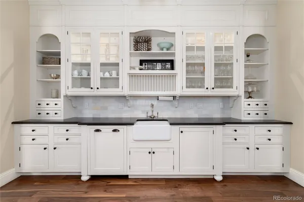 a kitchen with granite countertop a sink and cabinets