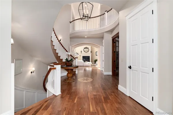 a living room with furniture fireplace and wooden floor