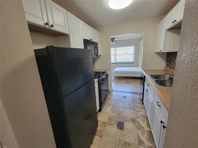 a kitchen with a refrigerator and a sink