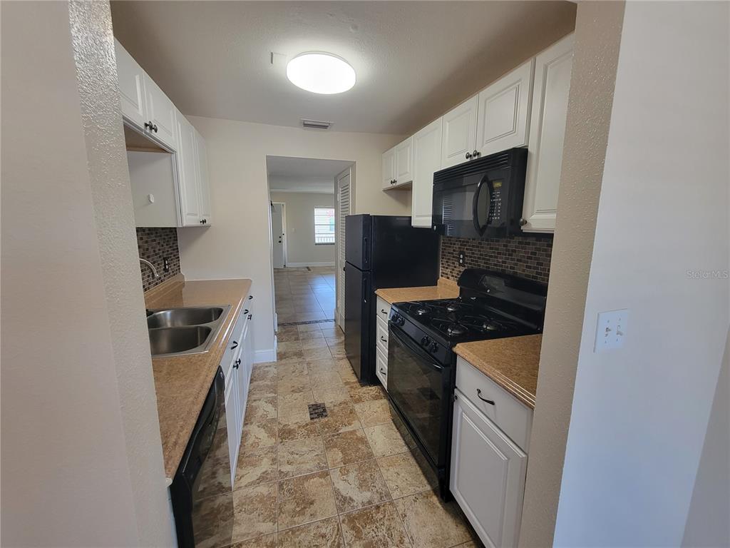 10032 65th Avenue North, Unit 19 St. Petersburg, FL 33708 - Photo 15 of 44 a kitchen with stainless steel appliances granite countertop a stove and a refrigerator