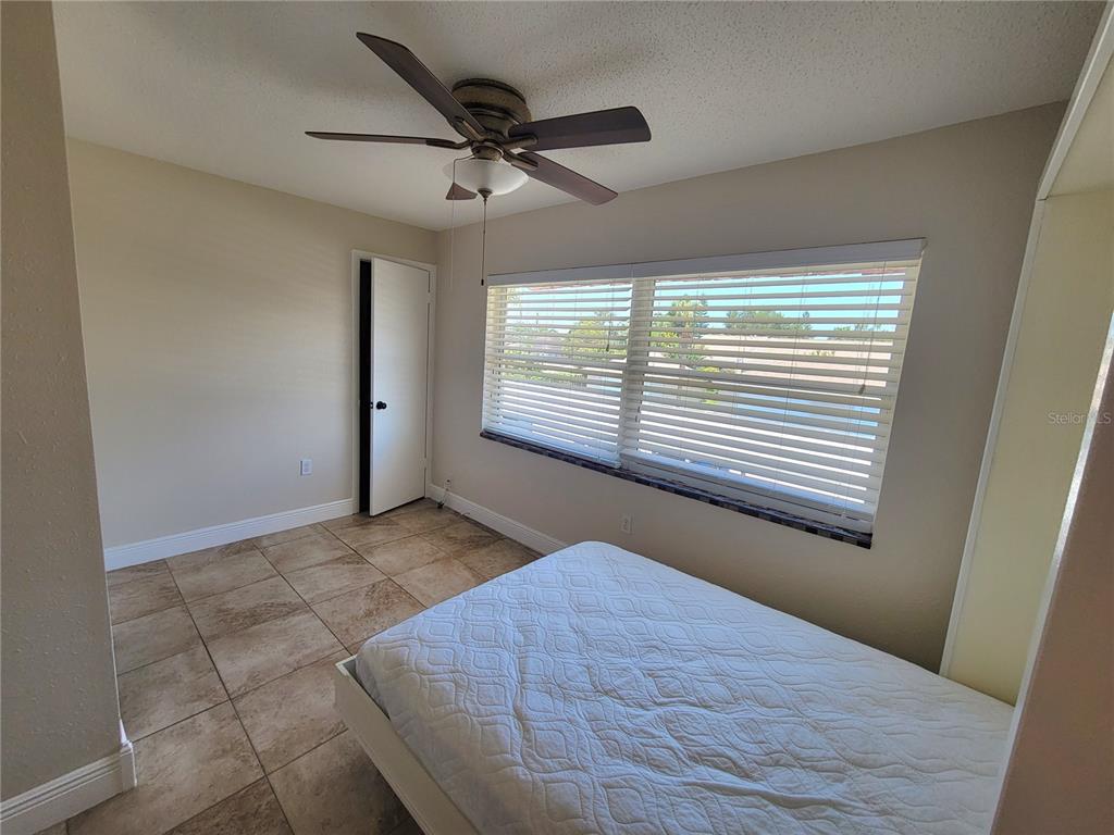 10032 65th Avenue North, Unit 19 St. Petersburg, FL 33708 - Photo 17 of 44 a view of an empty room with a window