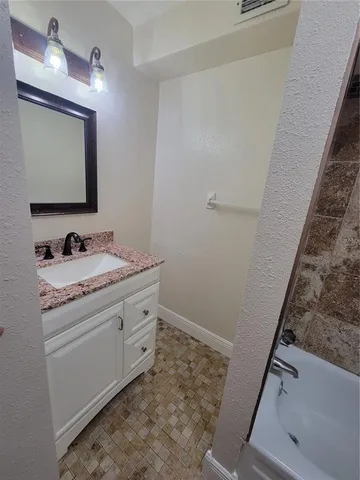 a bathroom with a tub and a shower